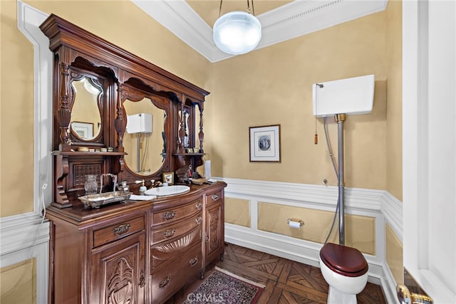 bathroom featuring crown molding, vanity, and parquet flooring