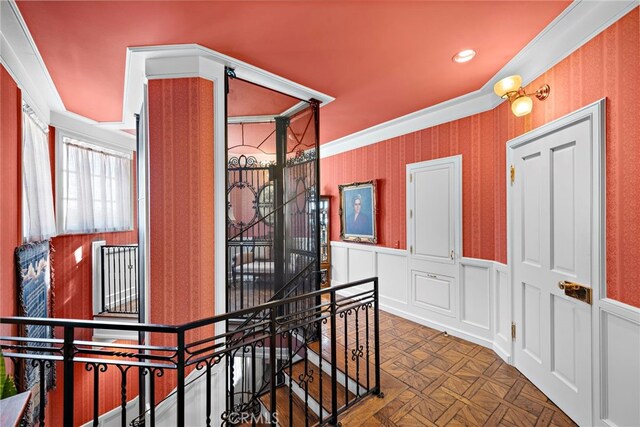 hallway featuring dark parquet flooring and crown molding