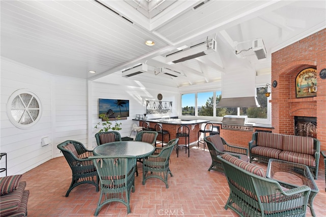 view of patio / terrace with area for grilling and an outdoor living space with a fireplace