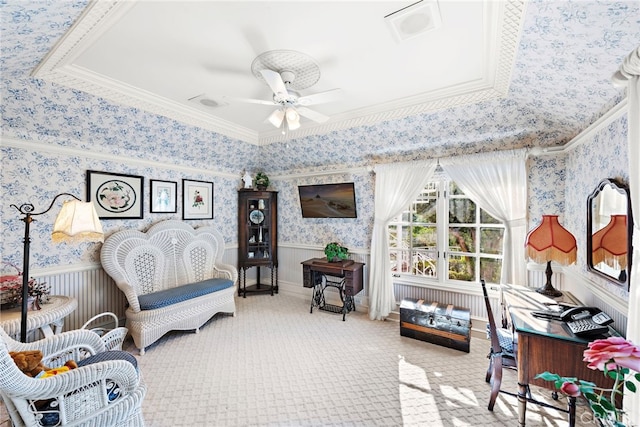 sitting room featuring ceiling fan, crown molding, and carpet floors