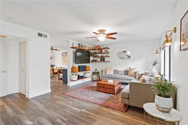 living room featuring ceiling fan and hardwood / wood-style floors