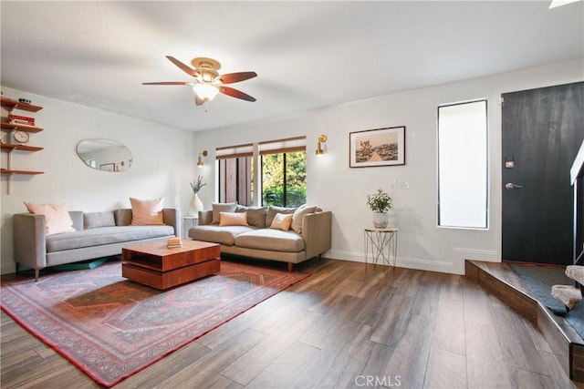 living room with ceiling fan and dark hardwood / wood-style flooring