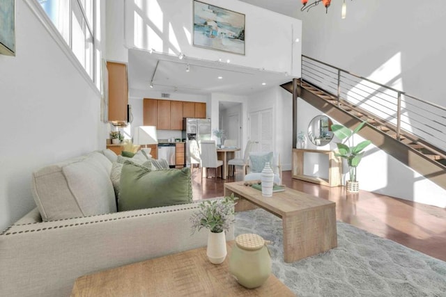 living room featuring a high ceiling and track lighting