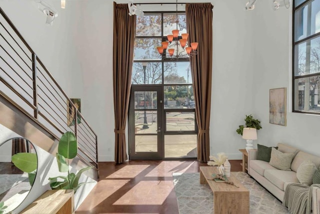 interior space with french doors and a chandelier