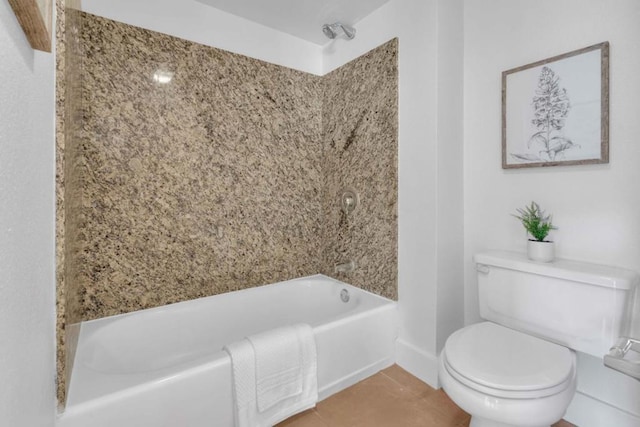 bathroom featuring tile patterned flooring, shower / bath combination, and toilet