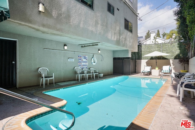 view of swimming pool with a patio area