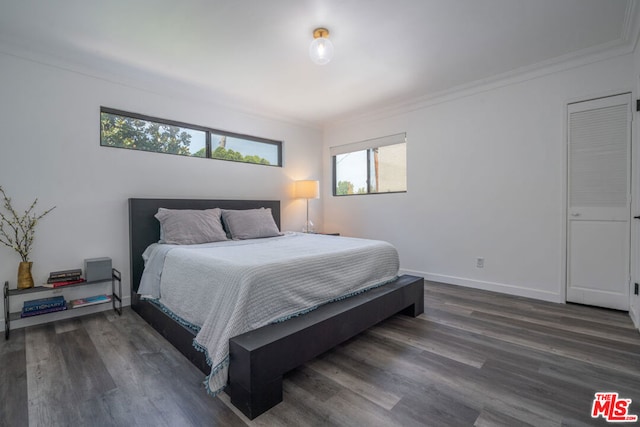 bedroom featuring ornamental molding and dark hardwood / wood-style floors