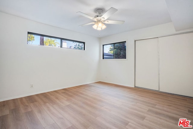 unfurnished bedroom with a closet, ceiling fan, and light hardwood / wood-style floors