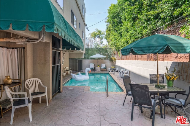 view of swimming pool featuring a patio