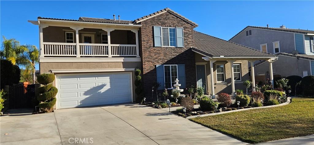 view of front of property with a balcony and a garage