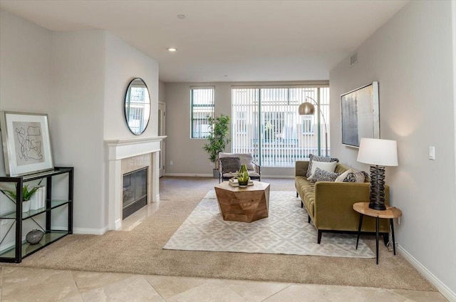 carpeted living room featuring a fireplace