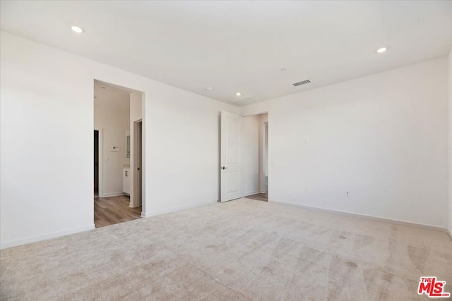 unfurnished room with light colored carpet