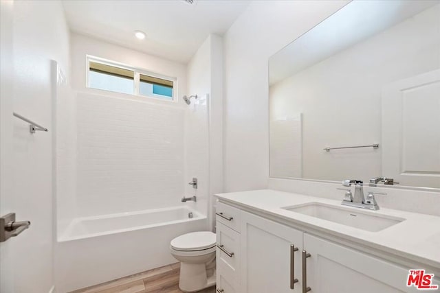 full bathroom featuring vanity, hardwood / wood-style floors, shower / tub combination, and toilet