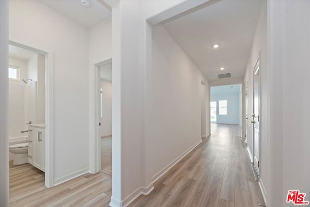 corridor with light hardwood / wood-style flooring