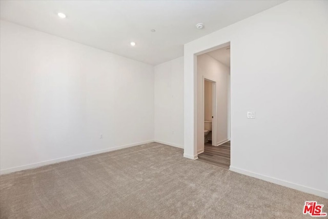 spare room with light carpet