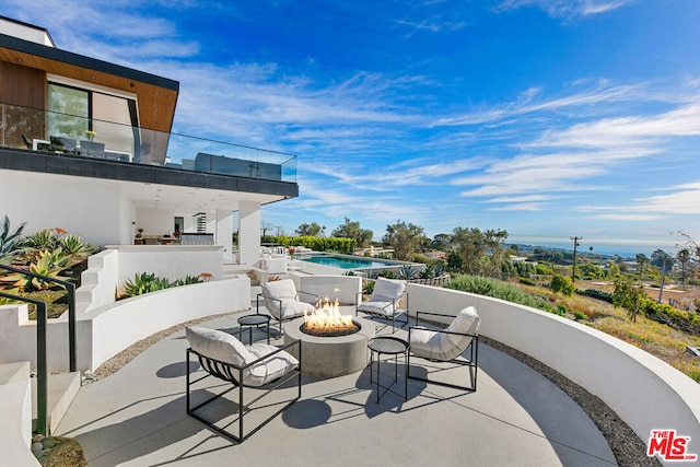 view of patio / terrace featuring a fire pit