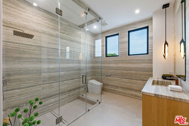 bathroom featuring toilet, vanity, tile patterned flooring, and an enclosed shower