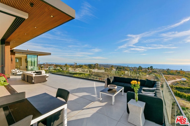 view of patio with a water view and an outdoor hangout area