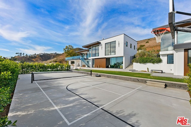 view of sport court with basketball hoop