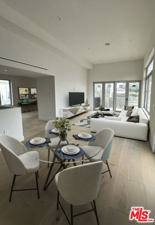 dining room featuring a healthy amount of sunlight and light hardwood / wood-style flooring