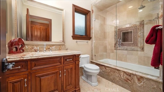 full bathroom featuring toilet, vanity, and shower / bath combination with glass door