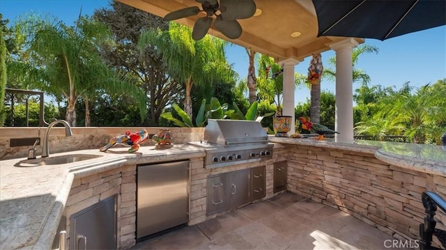 view of patio / terrace featuring an outdoor kitchen, grilling area, and sink