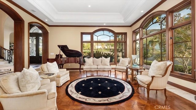 interior space featuring a tray ceiling, parquet flooring, and ornamental molding