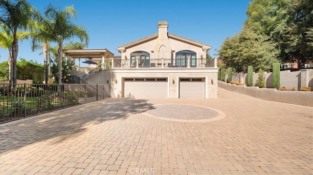 view of front facade with a garage and a balcony