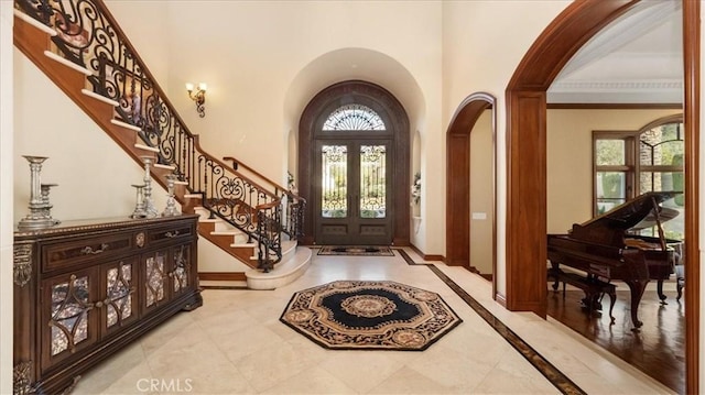 foyer with french doors and ornamental molding