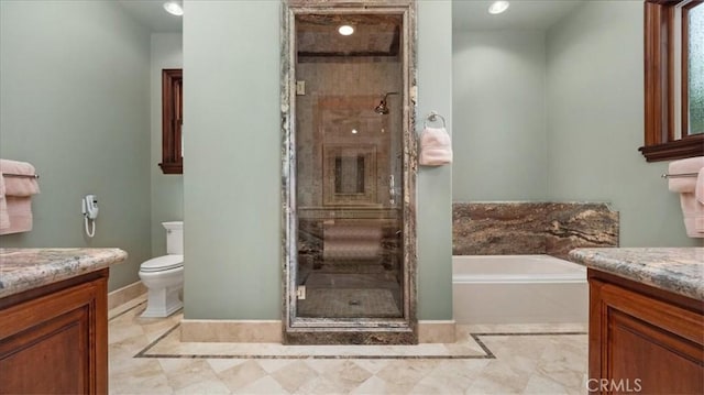 full bathroom featuring vanity, toilet, and separate shower and tub