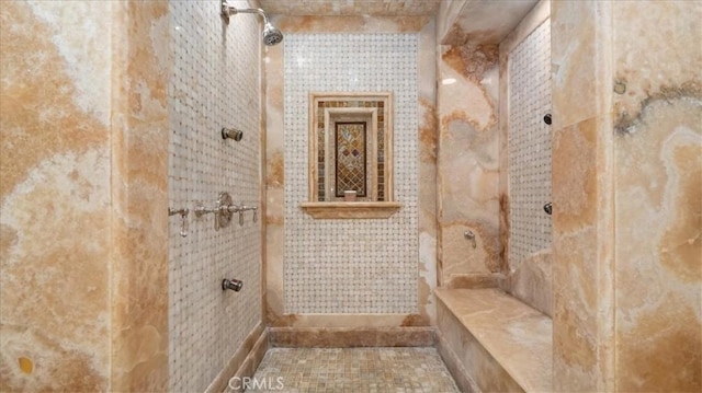 bathroom with tiled shower