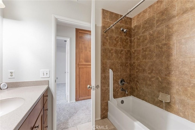 bathroom with tiled shower / bath, tile patterned floors, and vanity