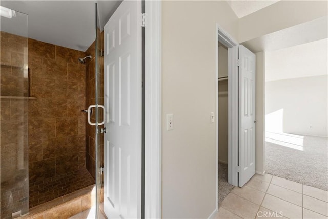 bathroom with walk in shower and tile patterned floors