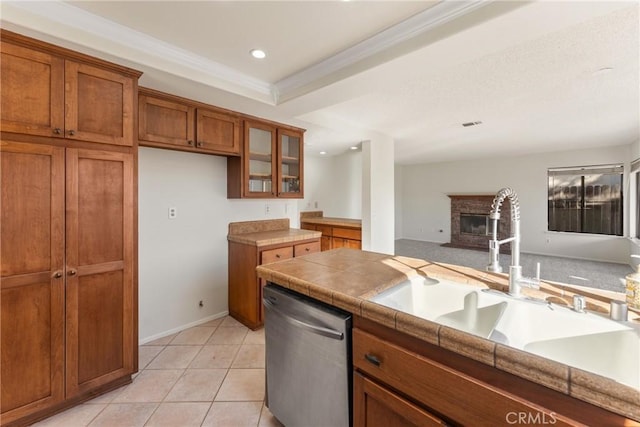 kitchen with dishwasher, tile countertops, sink, crown molding, and light tile patterned floors