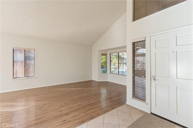 tiled entryway with high vaulted ceiling