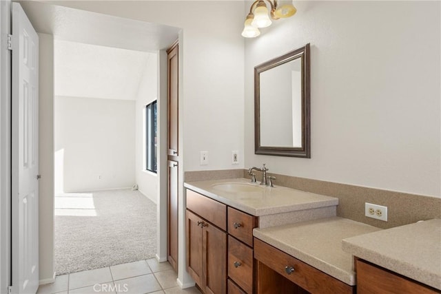 bathroom featuring lofted ceiling, vanity, and tile patterned flooring