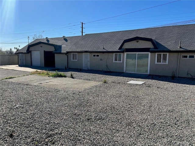 rear view of house featuring a garage