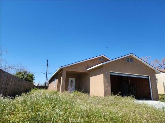 view of side of home with a garage