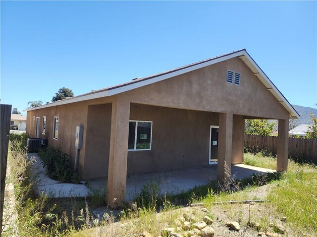 rear view of property featuring cooling unit and a patio