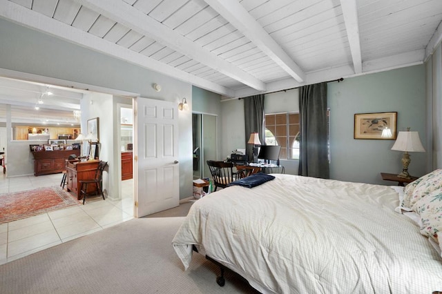 bedroom with beam ceiling and light tile patterned floors