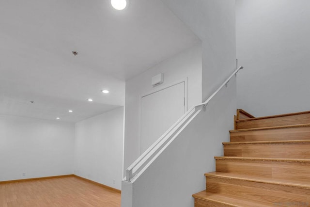 staircase with hardwood / wood-style floors