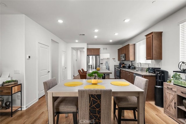 kitchen with a healthy amount of sunlight, sink, stainless steel appliances, and a kitchen island