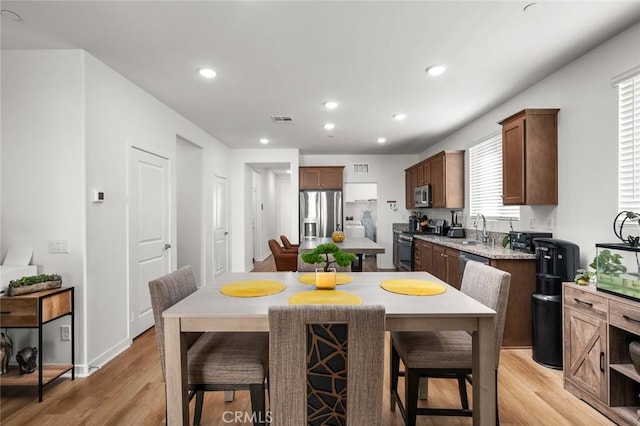 5097 Larkspur Rd, Banning, CA 92220 - kitchen featuring stainless steel appliances, light wood-style floors, a sink, recessed lighting, and light stone countertops