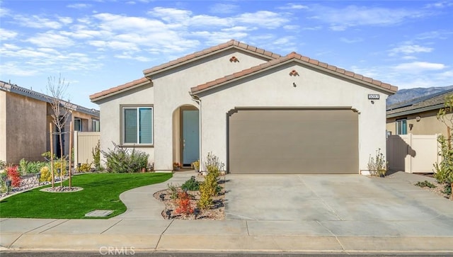5097 Larkspur Rd, Banning, CA 92220 - mediterranean / spanish-style home with an attached garage, stucco siding, driveway, and a tiled roof
