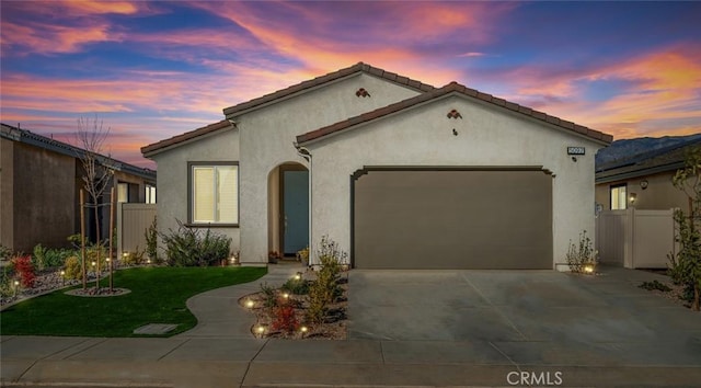 5097 Larkspur Rd, Banning, CA 92220 - mediterranean / spanish-style house with an attached garage, driveway, and stucco siding