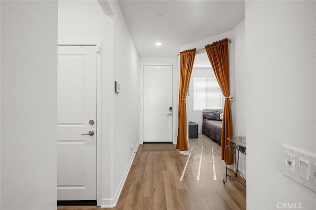 hall with light hardwood / wood-style flooring