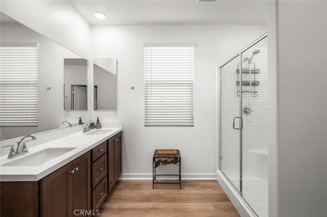 bathroom featuring walk in shower, vanity, and hardwood / wood-style floors