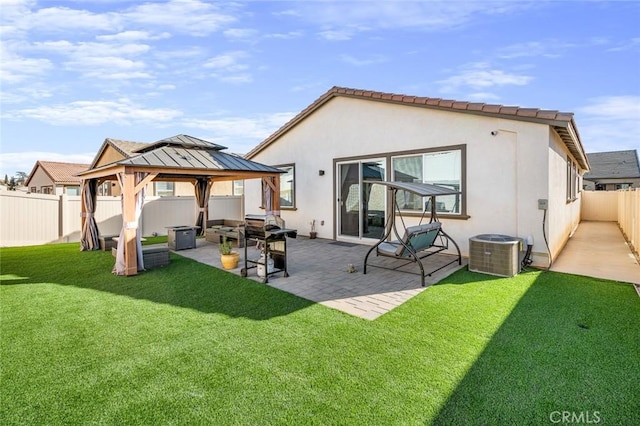 back of house with a patio area, a gazebo, a yard, and cooling unit