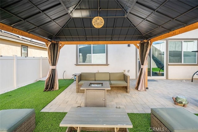 view of patio / terrace with an outdoor living space with a fire pit and a gazebo