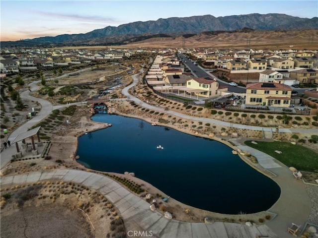 aerial view featuring a water and mountain view